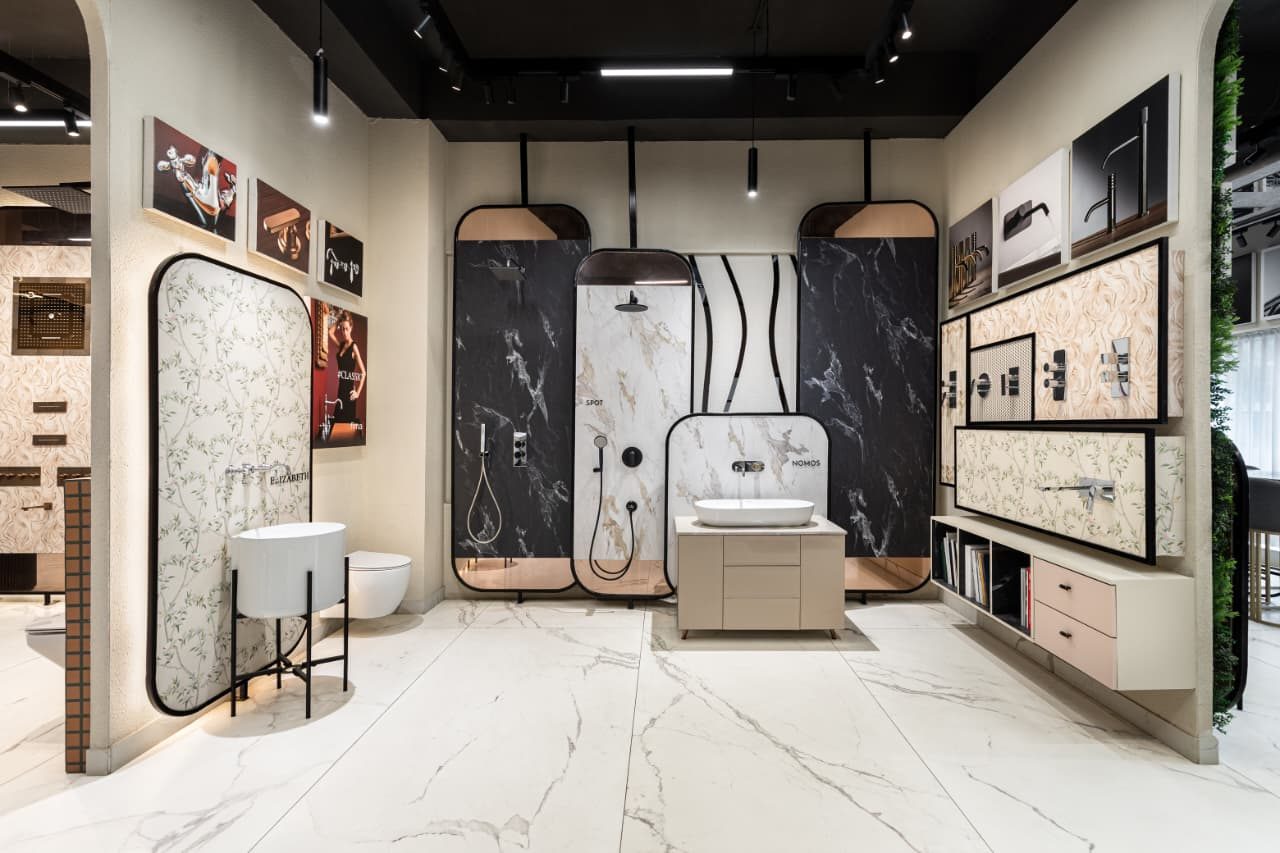 Italian and premium bath fittings displayed on marble plates at IDC, Mohali